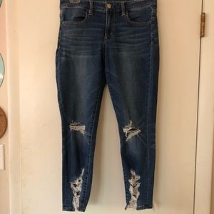 Blue skinny jeans with rips at knees and bottom